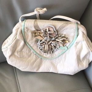 White Leather Shoulder bag with flower embellishments.